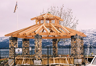 Custom designed octagonal lakefront timber frame gazebo with stone posts by Log and Timber Works Saskatchewan