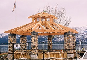 Custom designed octagonal lakefront timber frame gazebo with stone posts by Log and Timber Works British Columbia