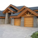 Custom designed exterior timber frame accents on a timber frame hybrid home by Log and Timber Works Saskatchewan