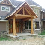 Log entrance truss, cedar flare posts and elements on a home by Log and Timber Works Saskatchewan