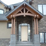 Custom designed timber frame truss, cluster posts and decorative accents on a home by Log and Timber Works Saskatchewan