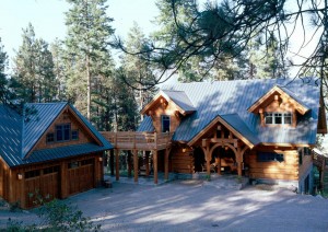 Dovetail log home with timber frame entrance and exterior catwalk by Log and Timber Works Saskatchewan
