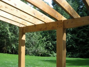 Timber posts, beams and rafters on timber frame porch addition by Log and Timber Works Saskatchewan