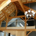 Exposed interior roof system of a timber frame home by Log and Timber Works Saskatchewan