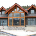 Exterior timber frame accents and elements on a timber frame home by Log and Timber Works Saskatchewan