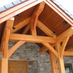 Timber frame entry and accents on a timber frame home by Log and Timber Works Saskatchewan