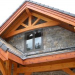Exterior timber frame accents and elements on a timber frame home by Log and Timber Works Saskatchewan