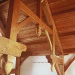 Timber frame hammer beam truss with carved acorn pendants by Log and Timber Works Saskatchewan