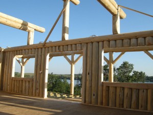 Lakefront vertical log cabin by Log and Timber Works Saskatchewan