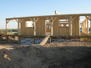 Lakefront vertical log cabin being constructed by Log and Timber Works Saskatchewan
