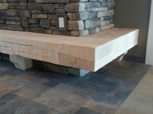 Dovetailed timber fireplace hearth with adzed finish by Log and Timber Works British Columbia