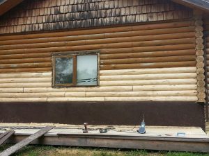 Log home during refinishing process by Log & Timber Works British Columbia