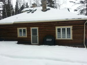Before photo of log home to be refinished and chinked by Log & Timber Works Saskatchewan