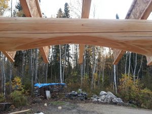 Vertical log home curved porch beam by Log & Timber Works British Columbia