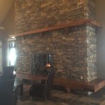 Timber frame mantel and hearth with dovetailed joinery by Log & Timber Works British Columbia